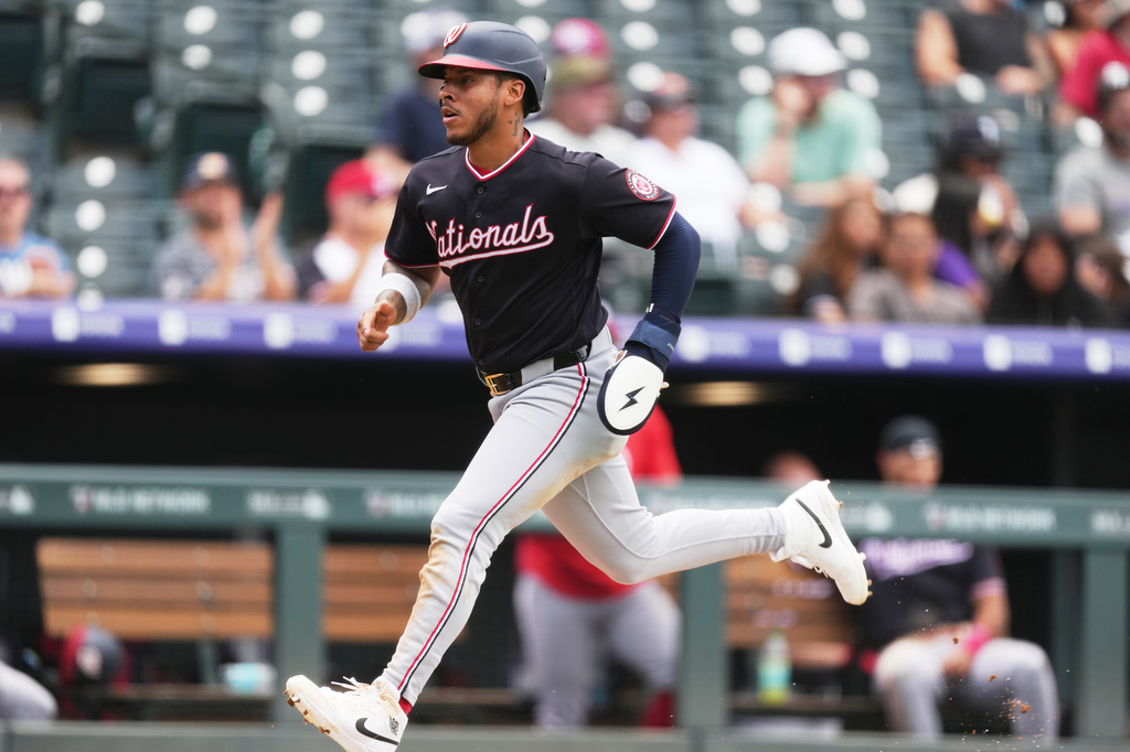 Washington Nationals' Jorbit Vivas scores on a sacrifice fly hit by James Wood off Colorado Rockies starting pitcher Gabriel Hughes in the fifth inning of a baseball game Wednesday, July 22, 2026, in Denver. (AP Photo/David Zalubowski)