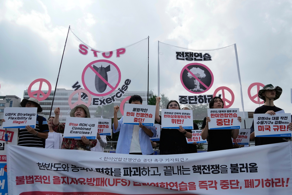 South Korean protesters stage a rally to oppose the joint military exercises, Ulchi Freedom Shield or UFS, between the U.S. and South Korea in front of the presidential office in Seoul, South Korea, Monday, Aug. 18, 2025. The banners read "Stop the military exercise between the U.S. and South Korea." (AP Photo/Ahn Young-joon)