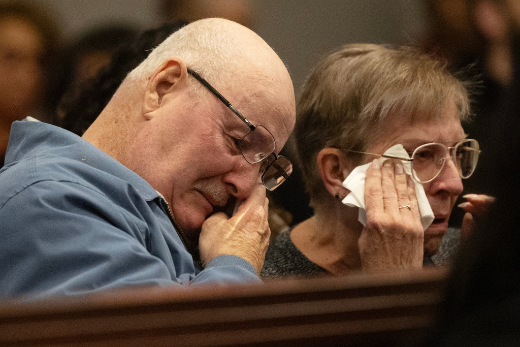 The parents of victim Mary Marshall wipe away tears in court in Raleigh, N.C., on Friday, Feb. 13, 2026, as Wake County Superior Court Judge Paul C. Ridgeway describes the victims of Austin Thompson before he was sentenced to life without parole. (Scott Sharpe/The News & Observer via AP, Pool)