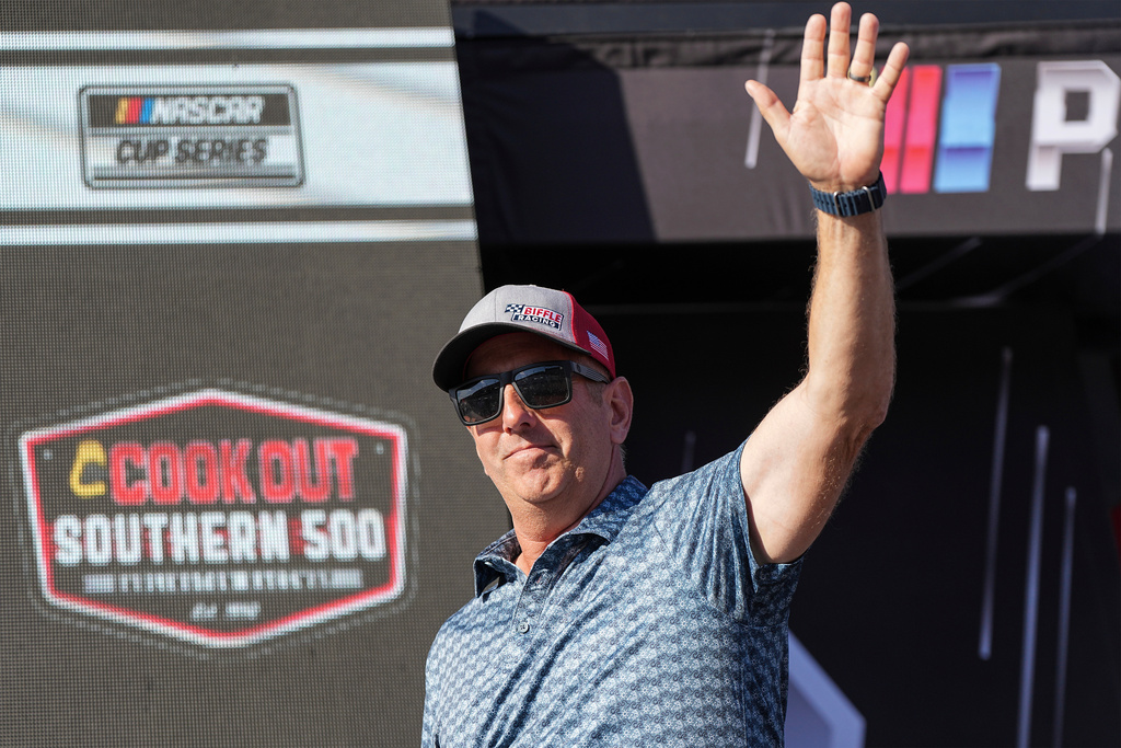 FILE - Former driver Greg Biffle waves to fans prior to a NASCAR Cup Series auto race at Darlington Raceway, Aug. 31, 2025, in Darlington, S.C. (AP Photo/Matt Kelley, File)