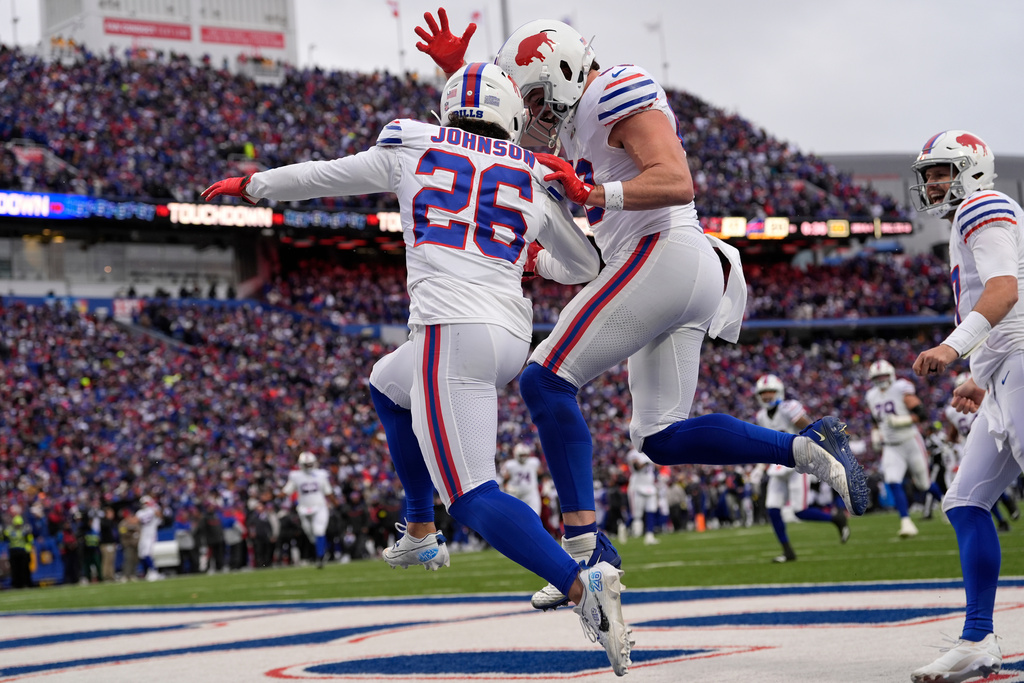 Buffalo Bills running back Ty Johnson (26) celebrates with tight end Dawson Knox, second from left, after scoring a touchdown against the Tampa Bay Buccaneers during the first half of an NFL football game, Sunday, Nov. 16, 2025, in Orchard Park, N.Y. (AP Photo/Carolyn Kaster)