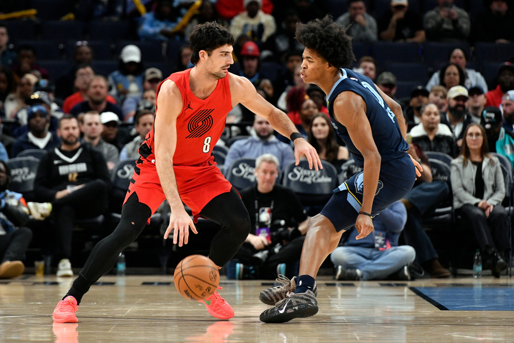 Portland Trail Blazers forward Deni Avdija (8) handles the ball against Memphis Grizzlies forward Jaylen Wells (0) in the first half of an NBA basketball game Sunday, Dec. 7, 2025, in Memphis, Tenn. (AP Photo/Brandon Dill)