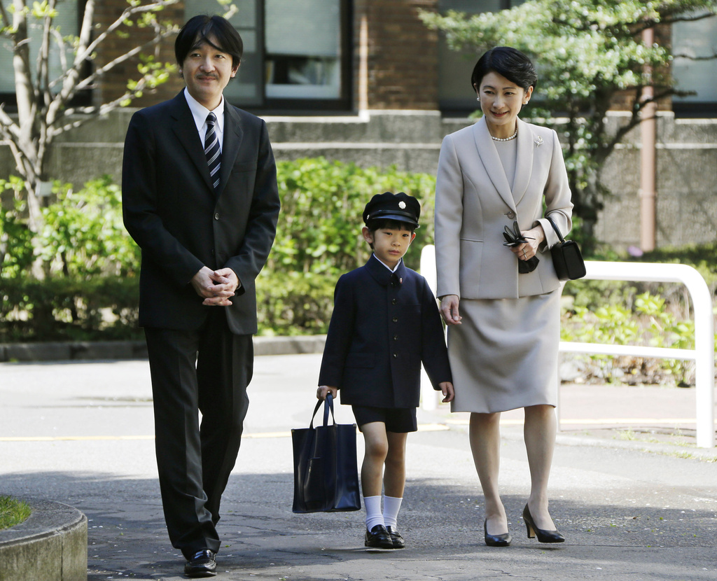 FILE - Japan's Prince Hisahito, center, accompanied by his parents Prince Akishino, left, and Princess Kiko, arrives at Ochanomizu University Elementary School for his entrance ceremony in Tokyo, Sunday, April 7, 2013. (AP Photo/Koji Sasahara, Pool, File)
