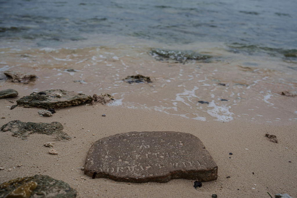 FILE - A gravestone lies near the shoreline on Pele Island, Vanuatu, July 18, 2025. (AP Photo/Annika Hammerschlag, File)