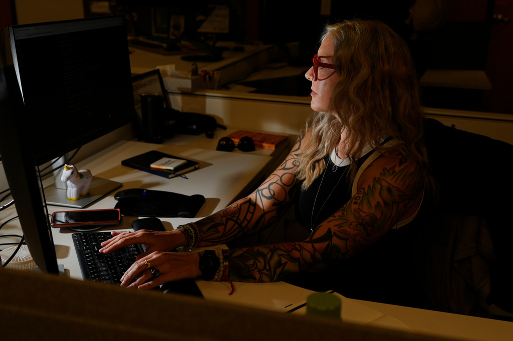 Deanna Danger types an AI prompt into her computer as she uses the technology to assist in her tasks as an administrative assistant at Vanderbilt University, Thursday, June 11, 2026, in Nashville, Tenn. (AP Photo/George Walker IV)