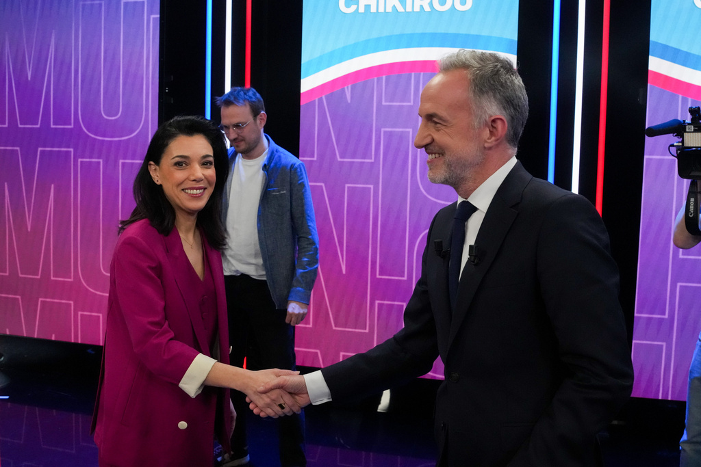 French socialist candidate for Paris mayoral election Emmanuel Gregoire, right, shakes hand with far-left candidate of La France Insoumise for Paris mayoral election, Sophia Chikirou, prior to a TV debate between the two rounds of the Paris municipal elections, Wednesday, March 18, 2026, in Paris. (AP Photo/Thibault Camus)