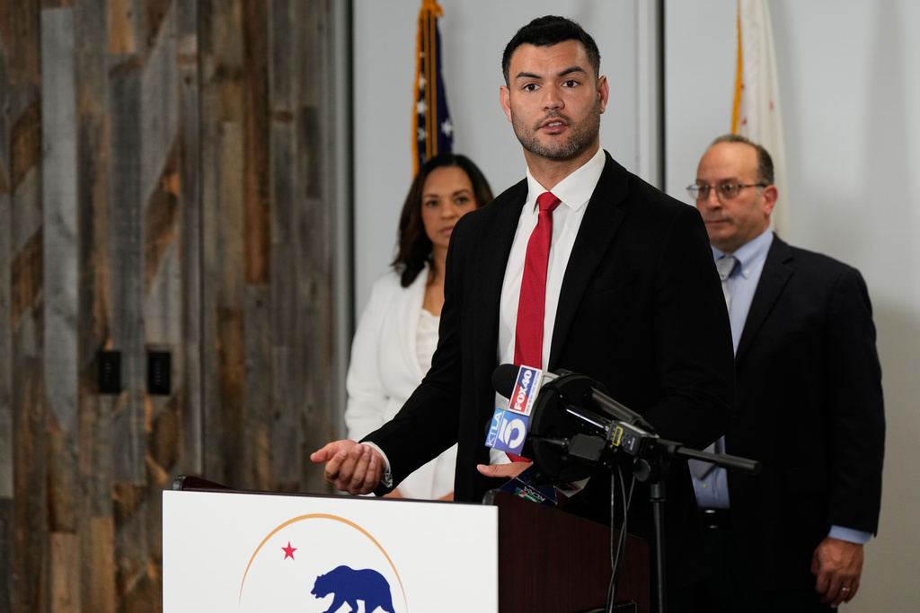 Republican assembly member David Tangipa, center, speaks to reporters during a press conference announcing a federal lawsuit challenging Proposition 50, Wednesday, Nov. 5, 2025, in Sacramento, Calif. (AP Photo/Godofredo A. Vásquez)