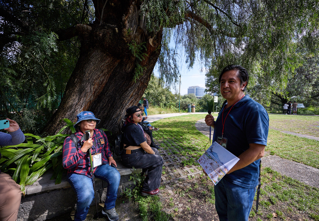 Archaeologist Pablo Martinez shows tourists a drawing of what the Cuicuilco Archaeological Zone used to look like, during a tour organized by the National Institute of Anthropology and History in Mexico City, Sunday, Oct. 5, 2025. (AP Photo/Ginnette Riquelme)