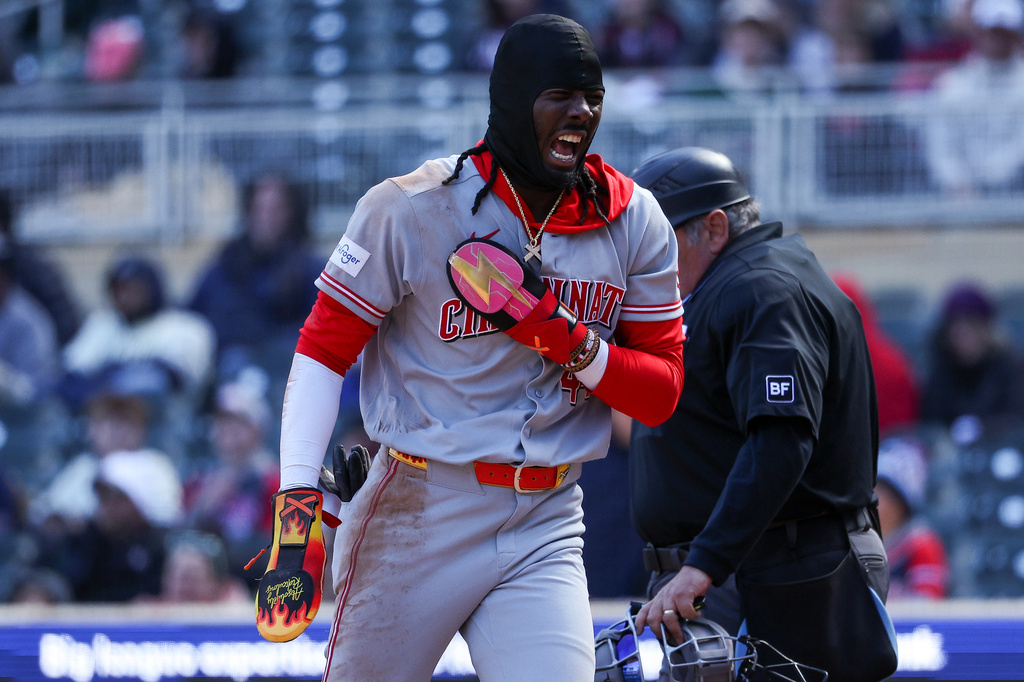 Cincinnati Reds' Elly de la Cruz reacts after scoring on a double hit by Eugenio Suárez during the 10th inning of baseball game against the Minnesota Twins, Sunday, April 19, 2026, in Minneapolis. (AP Photo/Matt Krohn)