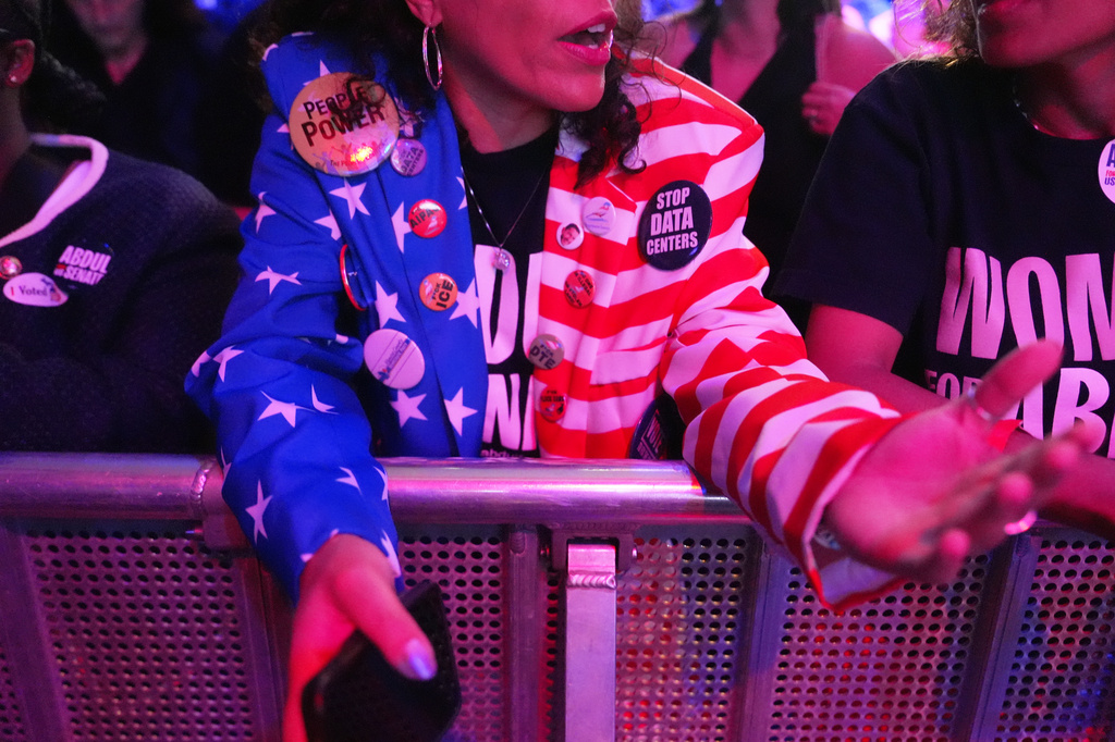 An attendee wears a pin reading "STOP DATA CENTERS" during a primary election night event for Abdul El-Sayed, a progressive candidate in the Democratic primary for U.S. Senate in Michigan, Tuesday, Aug. 4, 2026, at the Majestic Theatre in Detroit. (AP Photo/Julia Demaree Nikhinson)