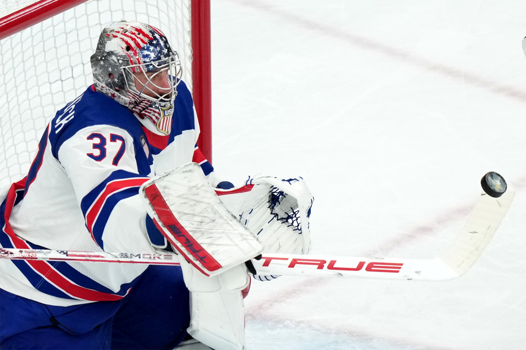FILE - United States goalkeeper Connor Hellebuyck blocks a shot against Canada during the third period of the men's ice hockey gold medal game at the 2026 Winter Olympics in Milan, Italy, Sunday, Feb. 22, 2026. (AP Photo/Carolyn Kaster, File)