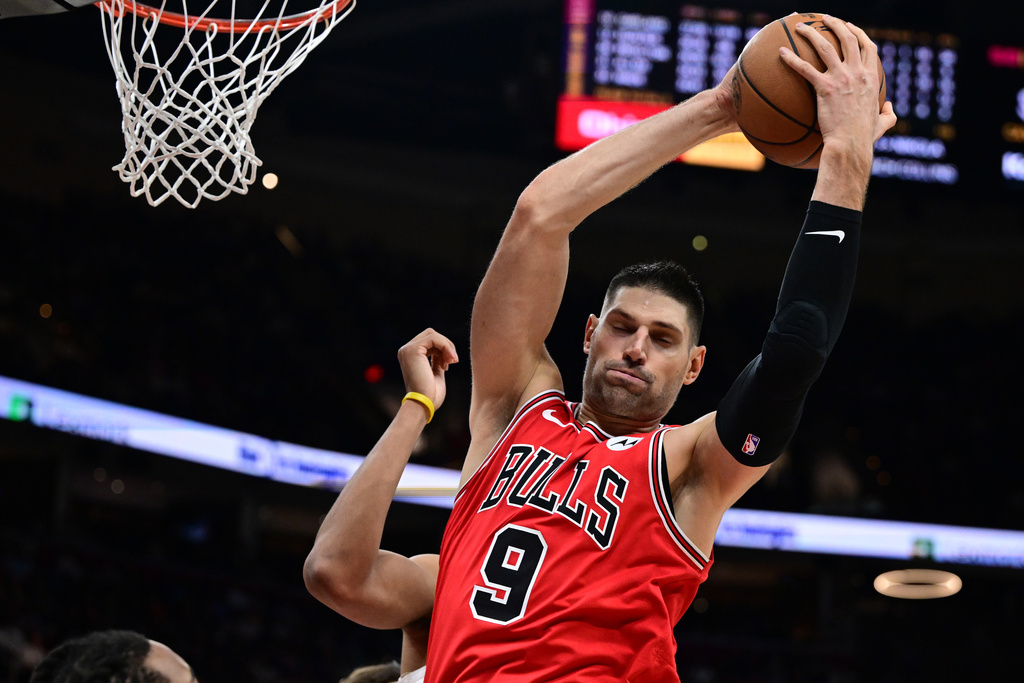 Chicago Bulls center Nikola Vucevic rebounds in the second half of an NBA basketball game against the Cleveland Cavaliers, Friday, Dec. 19, 2025, in Cleveland. (AP Photo/David Dermer)