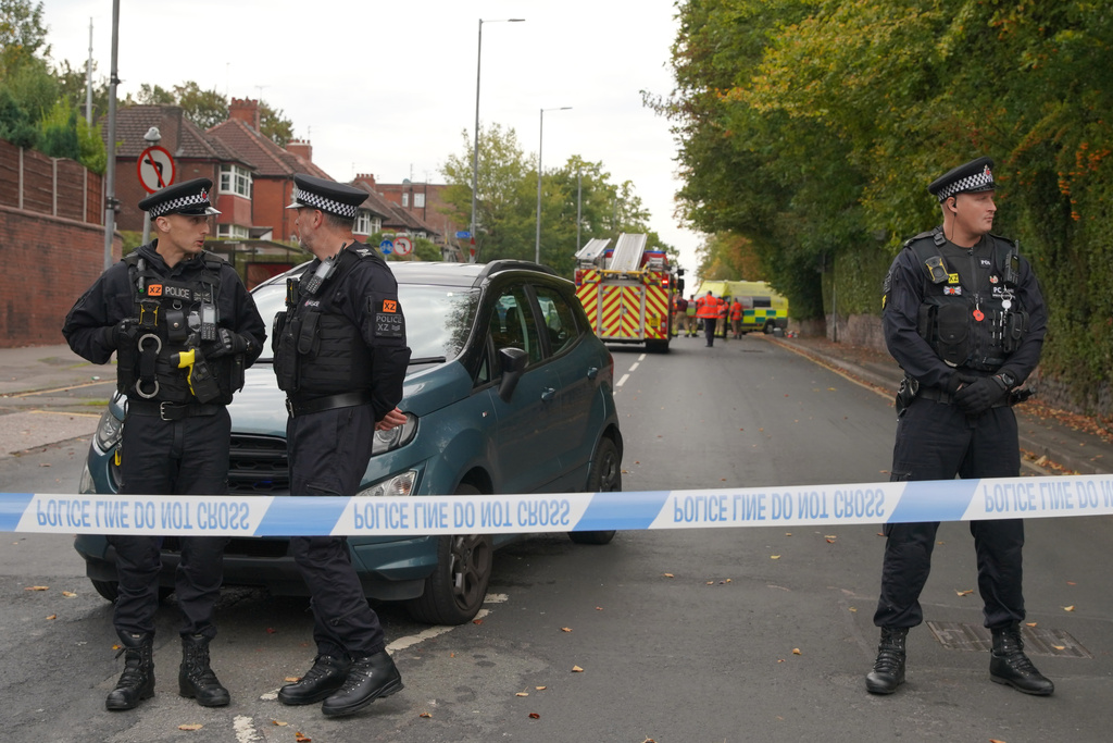 Police stand guard near the scene of a stabbing incident at Heaton Park Hebrew Congregation synagogue, in Crumpsall, Manchester, England, Thursday, Oct. 2, 2025. (AP Photo/Ian Hodgson)