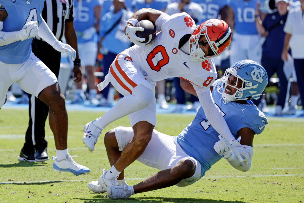 Clemson wide receiver Antonio Williams gets taken down by North Carolina linebacker Khmori House (7) during the first half of an NCAA college football game Saturday, Oct. 4, 2025, in Chapel Hill, N.C. (AP Photo/Chris Seward)