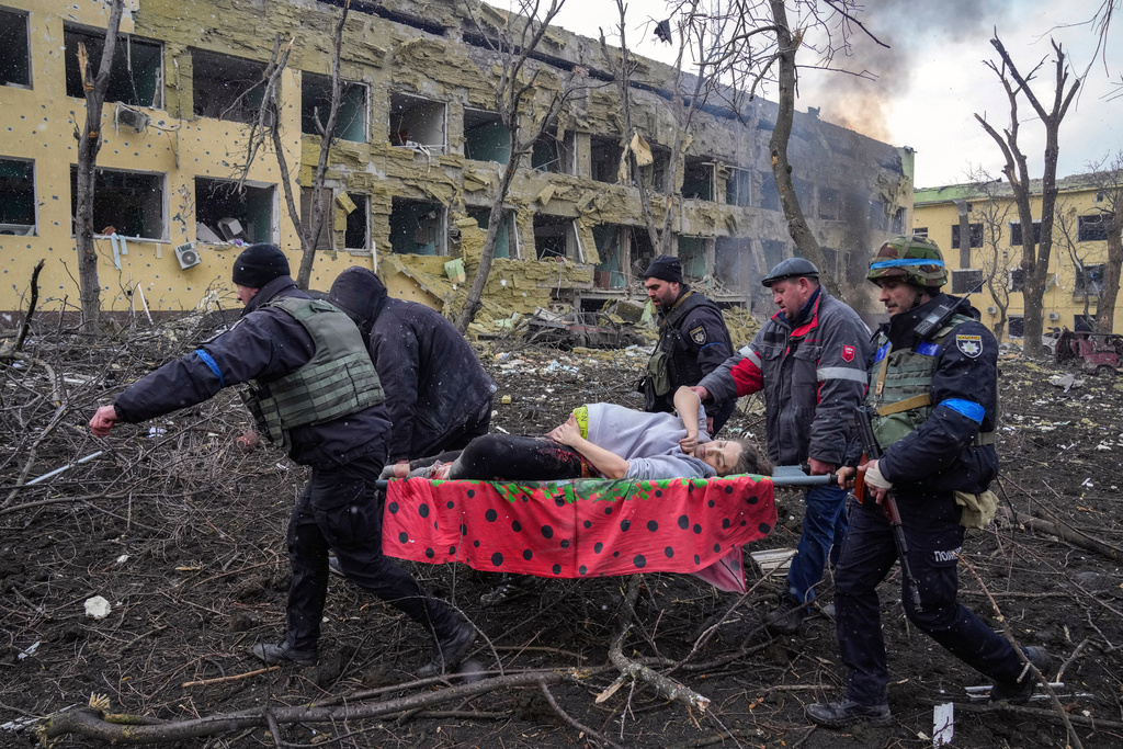 FILE - A pregnant woman whose pelvis had been crushed and her hip detached during Russian shelling is evacuated from a maternity in Mariupol, Ukraine, March 9, 2022. The woman was taken to another hospital closer to the front line but did not survive. (AP Photo/Evgeniy Maloletka, File)