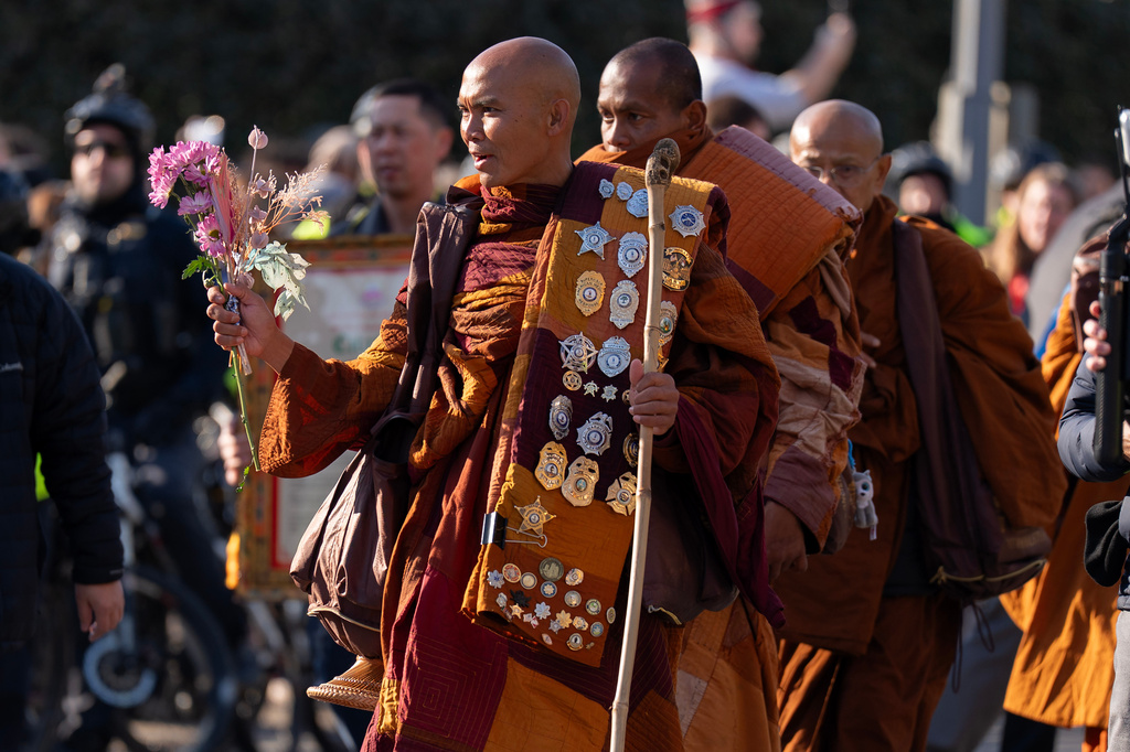 Monk Bhikkhu Pannakara walks along with Buddhist monks who are participating in a Walk For Peace walk through a the streets of Washington, Tuesday, Feb. 10, 2026, (AP Photo/Jose Luis Magana)