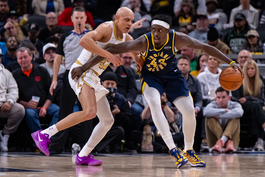 Indiana Pacers forward Pascal Siakam, right, works the ball inside against the defense of Boston Celtics guard Jordan Walsh, left, during the second half of an NBA basketball game in Indianapolis, Monday, Jan. 12, 2026. (AP Photo/Doug McSchooler)