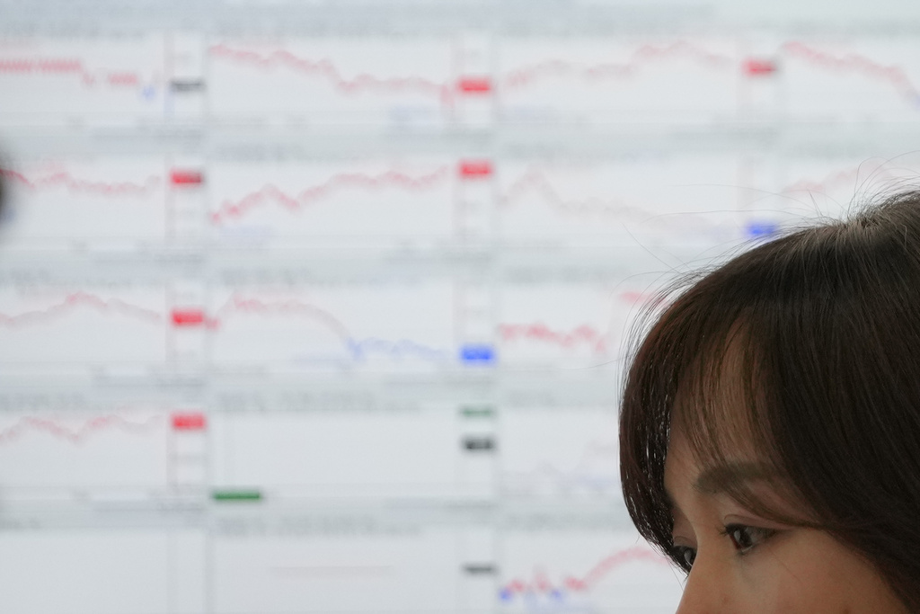 A dealer watches computer monitors at a dealing room of Hana Bank in Seoul, South Korea, Friday, Dec. 26, 2025. (AP Photo/Lee Jin-man)