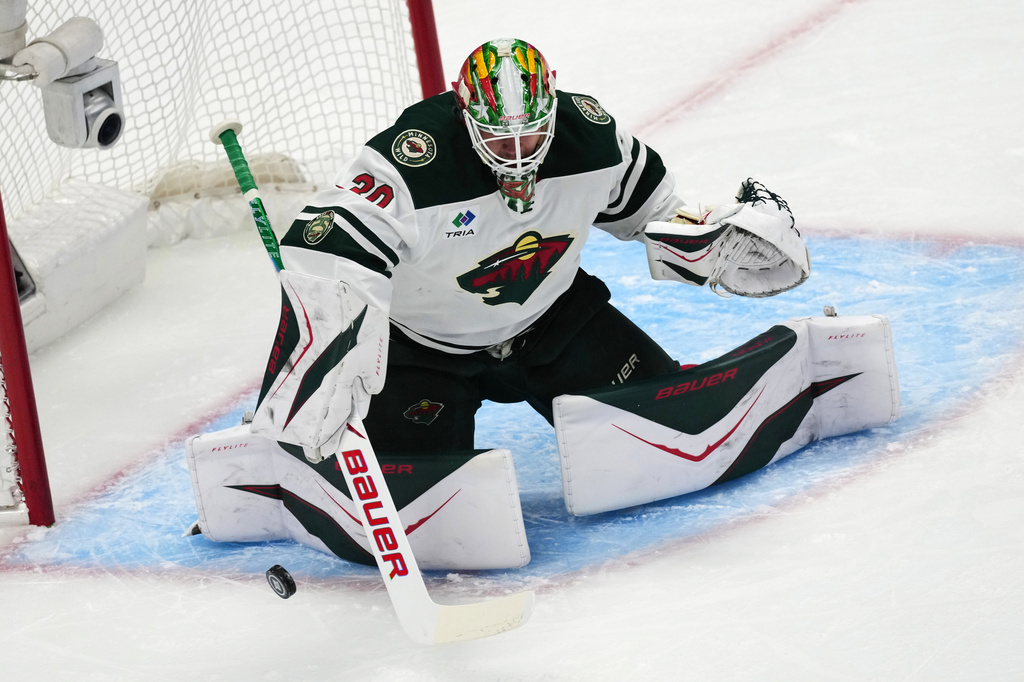 Minnesota Wild goaltender Jesper Wallstedt makes a stick-save in the first period of Game 1 of an NHL hockey Stanley Cup second-round playoff series against the Colorado Avalanche, Sunday, May 3, 2026, in Denver. (AP Photo/David Zalubowski)