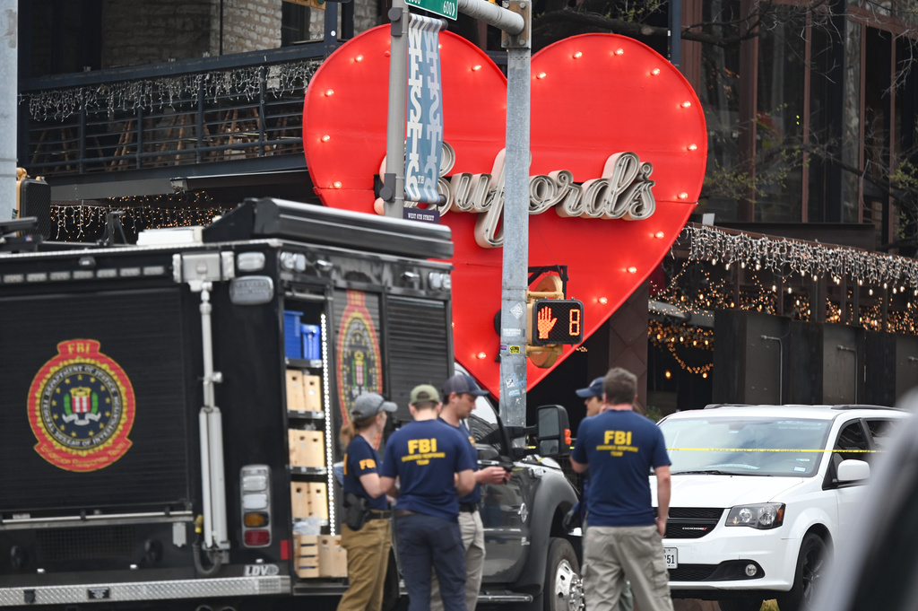 The Austin Police Department and the FBI investigate a shooting at Buford's on 6th Street on Sunday, March 1, 2026, in Austin, Texas. (AP Photo/Jack Myer)