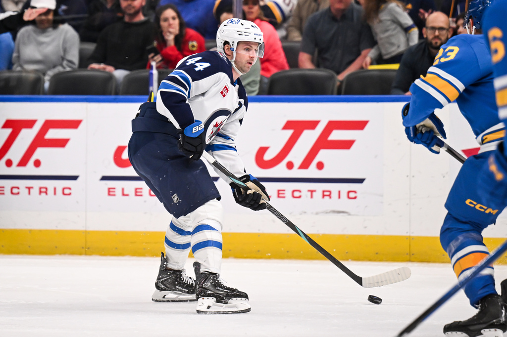 Winnipeg Jets' Josh Morrissey (44) handles the puck during the third period of an NHL hockey game against the St. Louis Blues, Thursday, April 9, 2026, in St. Louis. (AP Photo/Connor Hamilton)