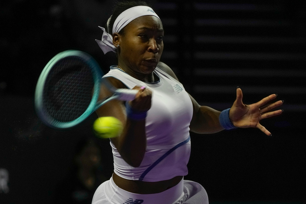 Coco Gauff of the United States plays a shot against Jasmine Paolini of Italy during their women's singles match at the WTA tennis finals in Riyadh, Saudi Arabia, Tuesday, Nov. 4, 2025. (AP Photo/ Fatima Shbair)