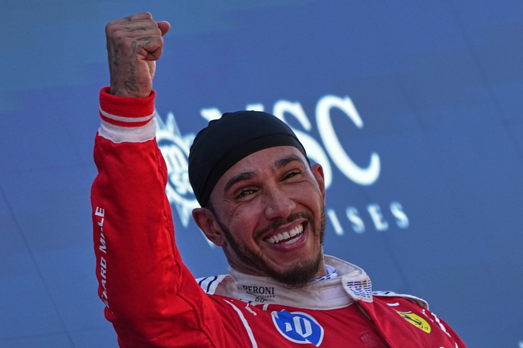 Ferrari driver Lewis Hamilton of Britain gestures at the podium after winning the Spain F1 Grand Prix race at the Barcelona Catalunya racetrack in Montmelo, near Barcelona, Spain, Sunday, June 14, 2026. (AP Photo/Fatima Shbair)