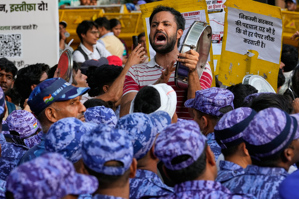 Supporters of the Cockroach Janta Party shout slogans during a protest demanding the resignation of Education Minister Dharmendra Pradhan over alleged examination irregularities and repeated paper leaks, in New Delhi, India, Saturday, June 20, 2026. (AP Photo/Manish Swarup)