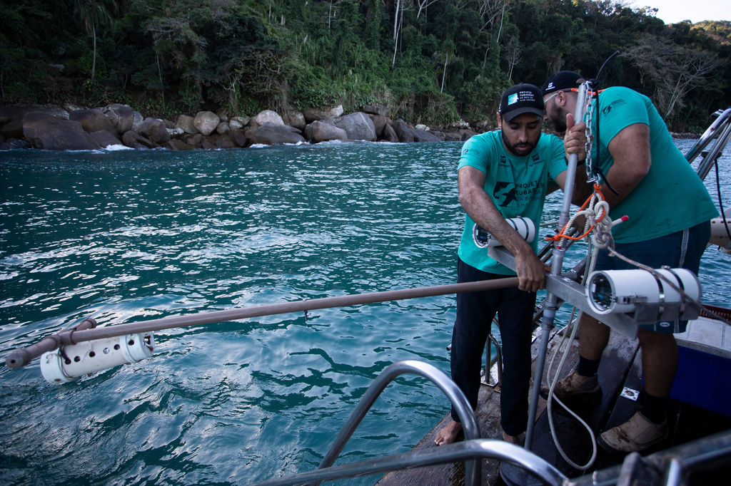 Scientific coordinator Leonardo Mitrano Neves, left, and field and logistics coordinator Daniel Shimada Brotto retrieve a Baited Remote Underwater Video System during monitoring as part of a shark project in Ilha Grande Bay, Angra dos Reis, Rio de Janeiro state, Brazil, July 14, 2026. (AP Photo/Bruna Prado)
