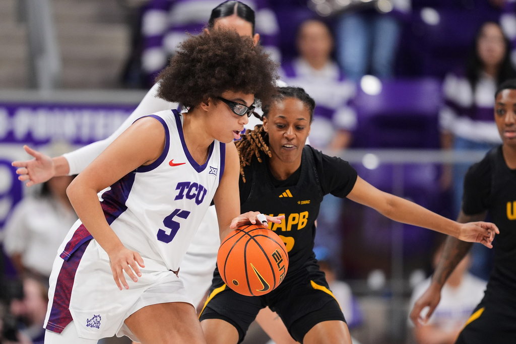TCU guard Olivia Miles (5) works against Arkansas Pine Bluff guard Jasmine Davis (2) in the first half of an NCAA women's basketball game in Fort Worth, Texas, Tuesday, Dec. 16, 2025. (AP Photo/Tony Gutierrez)