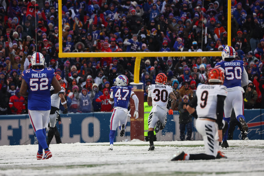 Buffalo Bills cornerback Christian Benford (47) runs for a touchdown after intercepting a pass by Cincinnati Bengals quarterback Joe Burrow (9) during the second half of an NFL football game, Sunday, Dec. 7, 2025, in Orchard Park, N.Y. Also seen are Buffalo Bills defensive tackle Jordan Phillips (52), Cincinnati Bengals running back Chase Brown (30) and Buffalo Bills defensive end Greg Rousseau (50). (AP Photo/Jeffrey T. Barnes)