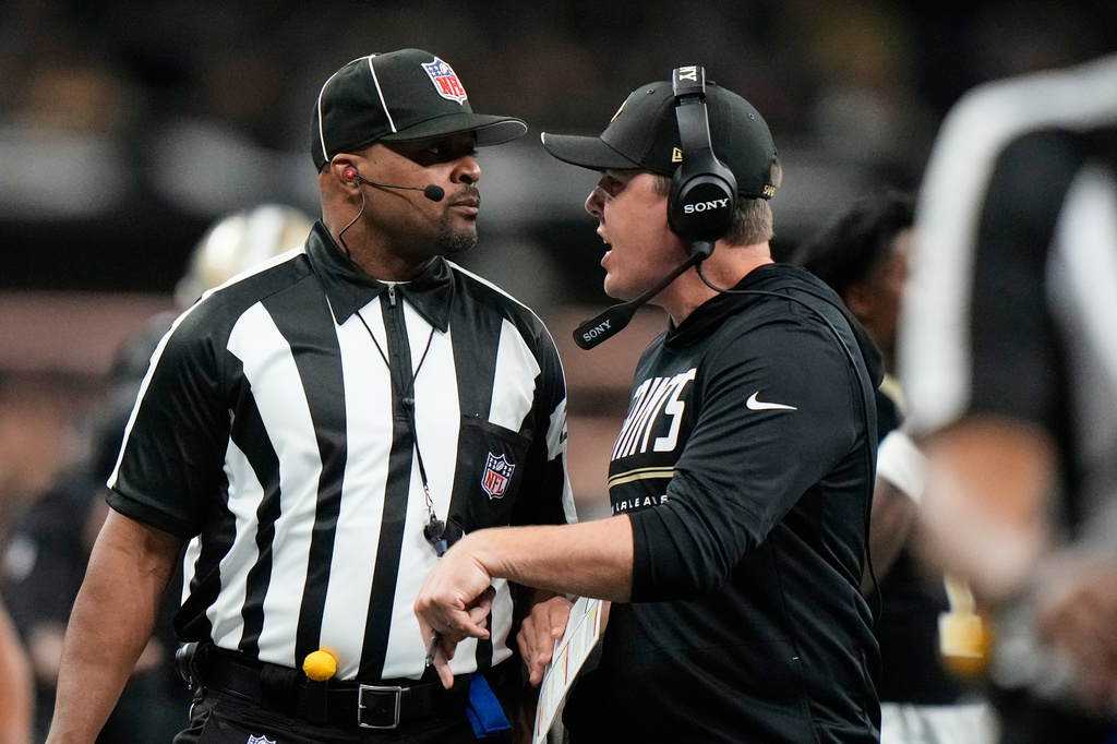 New Orleans Saints head coach Kellen Moore talks to an official after a penalty was issued to his team during the first half of an NFL football game against the Las Vegas Raiders in New Orleans, Sunday, Sept. 27, 2026. (AP Photo/Gerald Herbert)