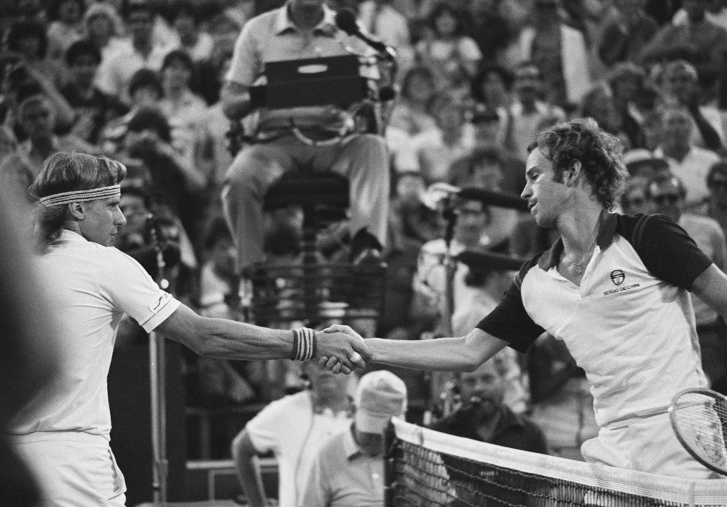 John McEnroe, right, shakes hands after defeating Björn Borg, left, in the final at the National Tennis Center in New York, Sept. 13, 1981. (AP Photo/Ron Frehm, File)