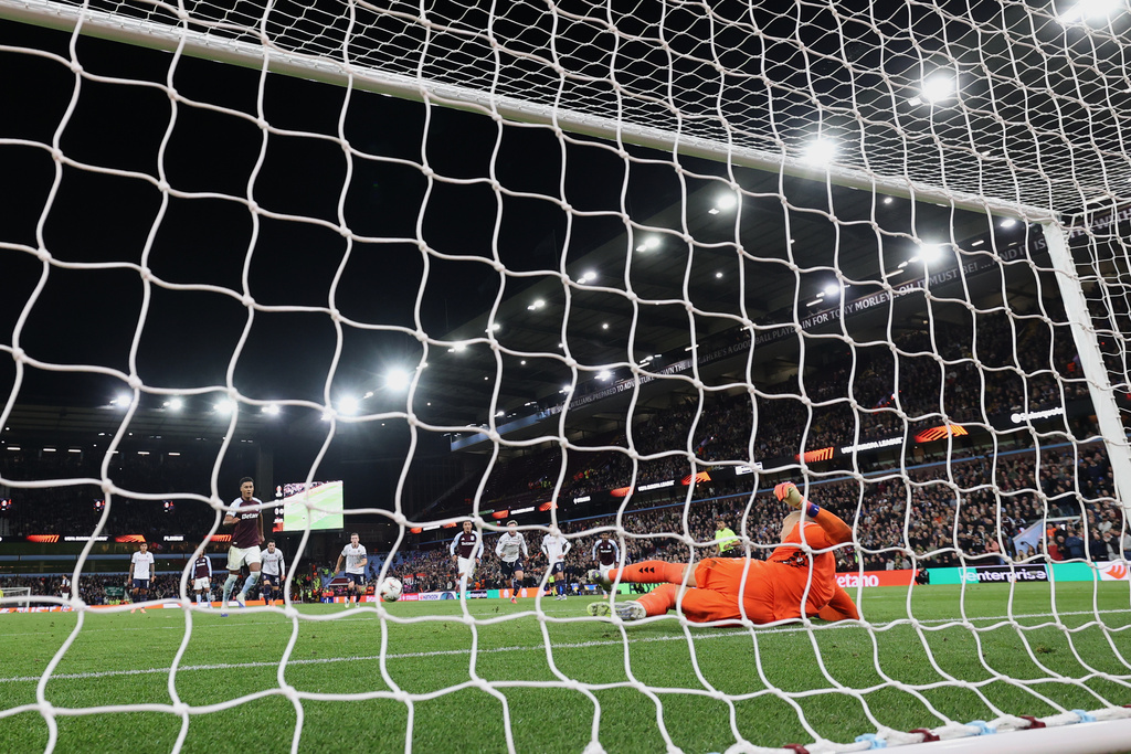 Aston Villa's Ollie Watkins, left, takes and misses a penalty during the Europa League soccer match between Aston Villa and Bologna at Villa Park stadium in Birmingham, England, Thursday, Sept. 25, 2025. (AP Photo/Darren Staples)