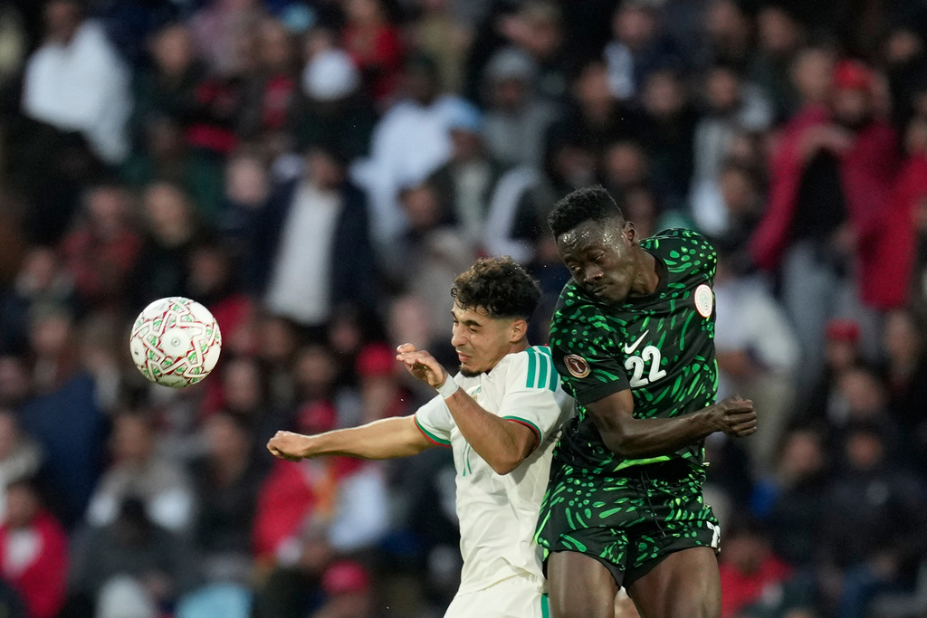 Algeria's Fares Chaibi, left, and Nigeria's Akor Adams challenge for the ball during the Africa Cup of Nations quarterfinal soccer match between Nigeria and Algeria, in Marrakech, Morocco, Saturday, Jan. 10, 2026. (AP Photo/Themba Hadebe)