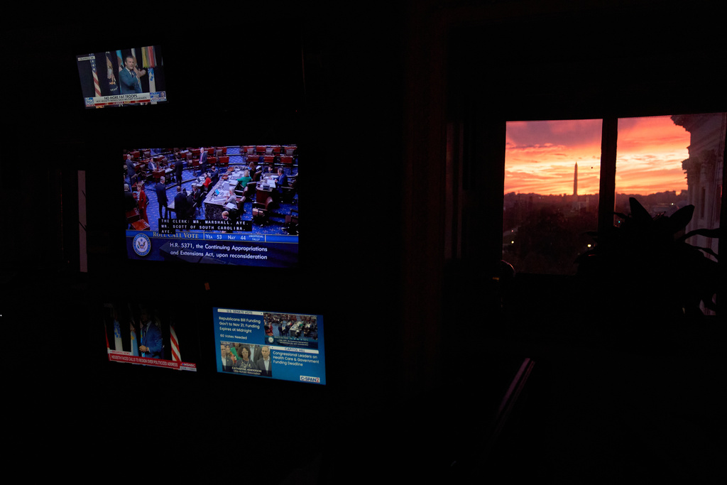 The sun sets behind the Capitol and Washington Monument, as a vote fails in the Senate which is expected to lead to a government shutdown, Tuesday, Sept. 30, 2025, as seen from inside the Capitol, in Washington. (AP Photo/Jacquelyn Martin)