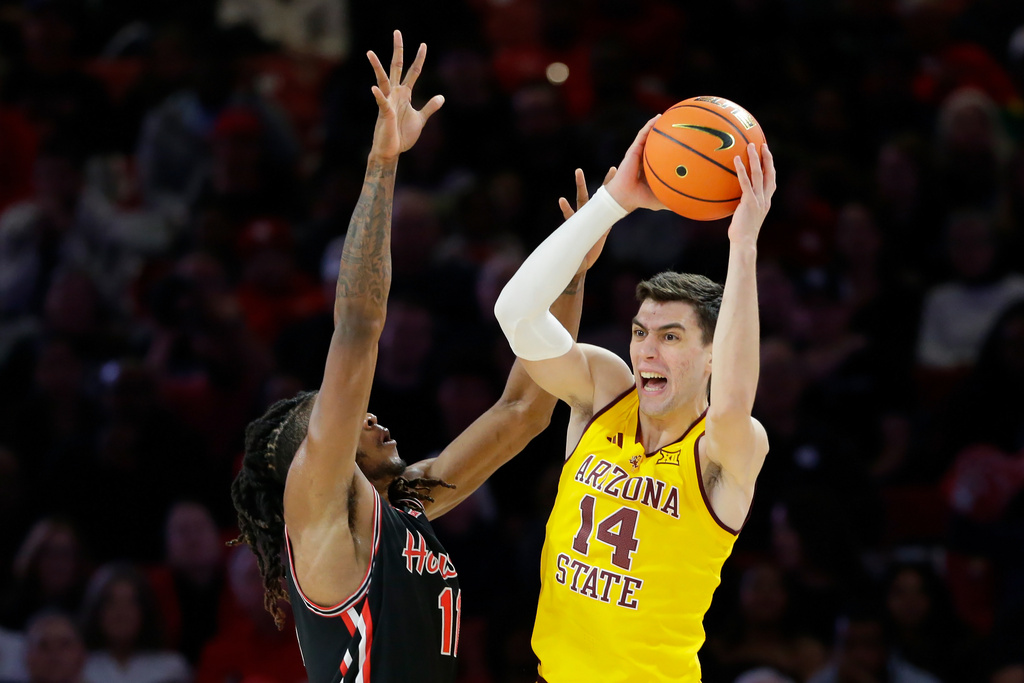 Arizona State forward Andrija Grbovic (14) passes the ball over Houston forward Joseph Tugler (11) during the first half of an NCAA college basketball game Sunday, Jan. 18, 2026, in Houston. (AP Photo/Michael Wyke)