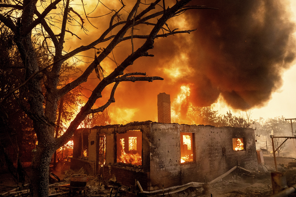 A home burns as the 6-5 Fire spreads through the Chinese Camp community of Tuolumne County, Calif., on Tuesday, Sept. 2, 2025. (AP Photo/Noah Berger)