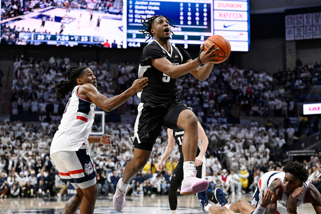 Providence forward Jamier Jones, right, goes up for a basket as UConn guard Silas Demary Jr., left, defends in the first half of an NCAA college basketball game, Tuesday, Jan. 27, 2026, in Storrs, Conn. (AP Photo/Jessica Hill)