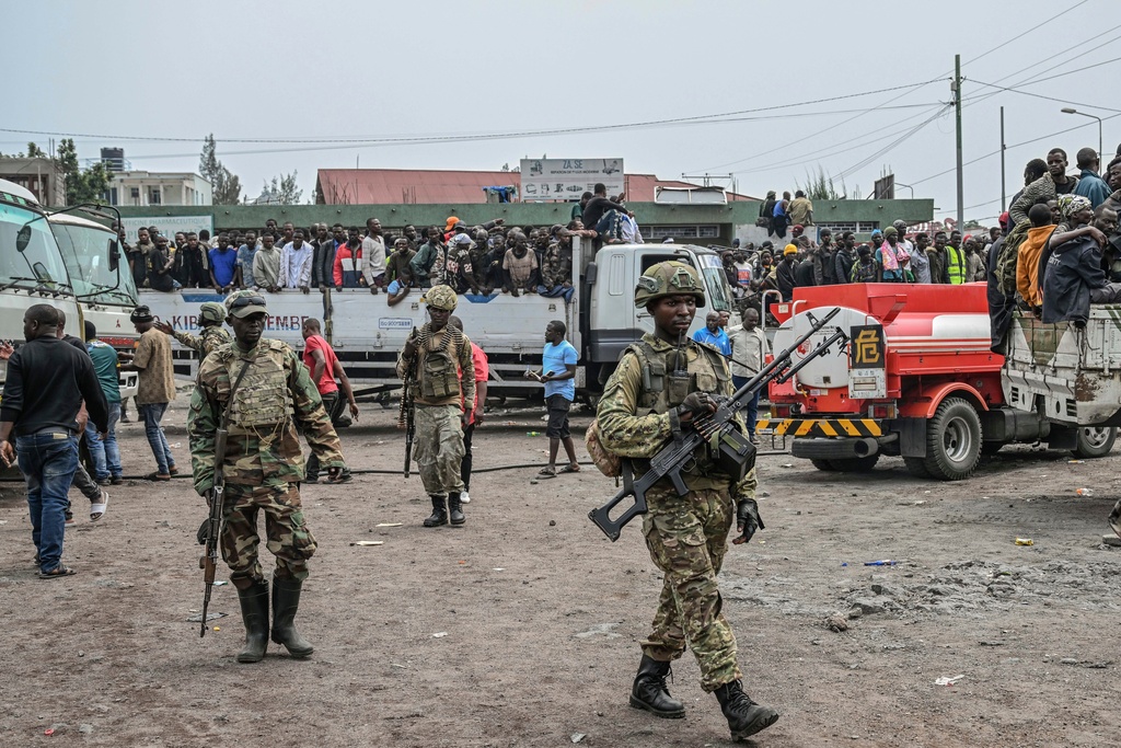 FILE - M23 rebels escort government soldiers and police who surrendered to an undisclosed location in Goma, Democratic republic of the Congo, Thursday, Jan. 30, 2025. (AP Photo/Moses Sawasawa, File)