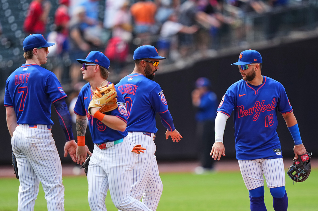 New York Mets' Bo Bichette, right, celebrates with teammates Marcus Semien, A.J. Ewing, second from left, and Brett Baty, left, after a baseball game against the St. Louis Cardinals Thursday, June 11, 2026, in New York. (AP Photo/Frank Franklin II)