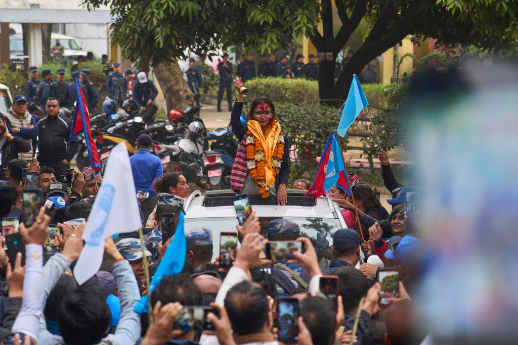 Supporters of Rastriya Swatantra Party celebrate the victory of Toshima Karki, a candidate for a seat in the House of Representatives in Lalitpur, Nepal, Saturday, March 7, 2026. (AP Photo/Niranjan Shrestha)