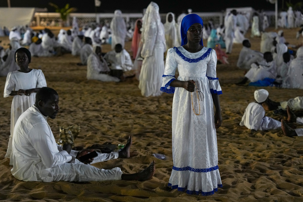 A girl dressed in a white gown holds prayer beads as people mark Prophet Muhammad's birthday, known as Mawlid, in Dakar, Senegal, Thursday, Sept 4, 2025. (AP Photo/Misper Apawu)