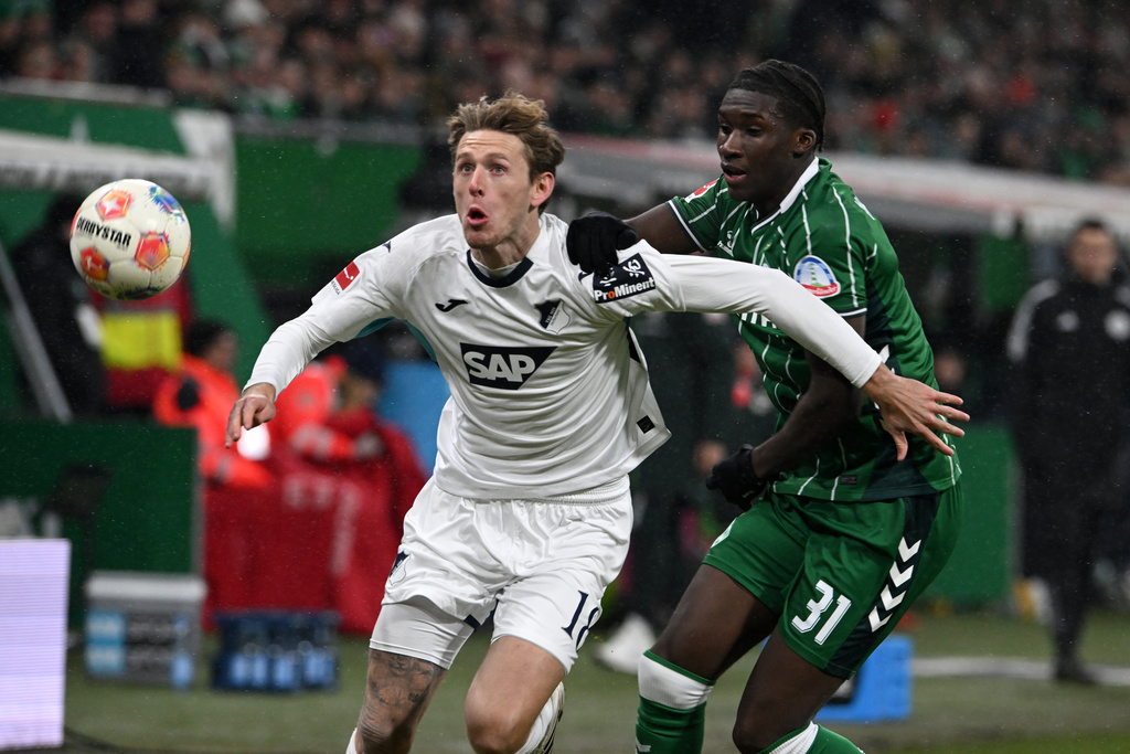 Hoffenheim's Wouter Burger, left, and Bremen's Karim Coulibaly fight for the ball during the German Bundesliga soccer match between Werder Bremen and TSG Hoffenheim 1899 in Bremen, Germany, Tuesday, Jan. 27, 2026. (Carmen Jaspersen/dpa via AP)