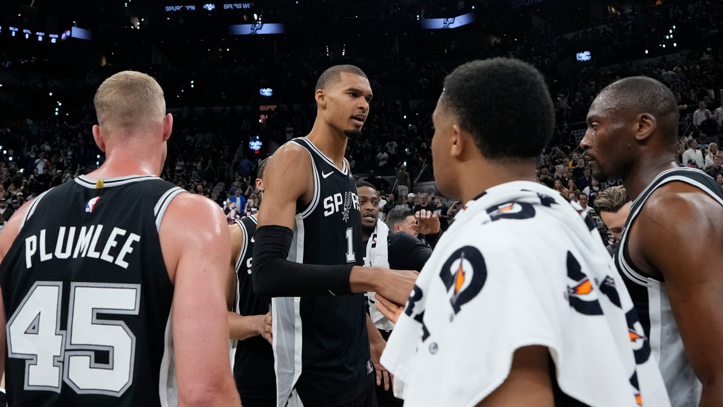 San Antonio Spurs forward Victor Wembanyama (1) speaks to reammates after a win over the Oklahoma City Thunder after Game 6 in the Western Conference finals NBA basketball playoffs series, Thursday, May 28, 2026, in San Antonio. (AP Photo/David J. Phillip)