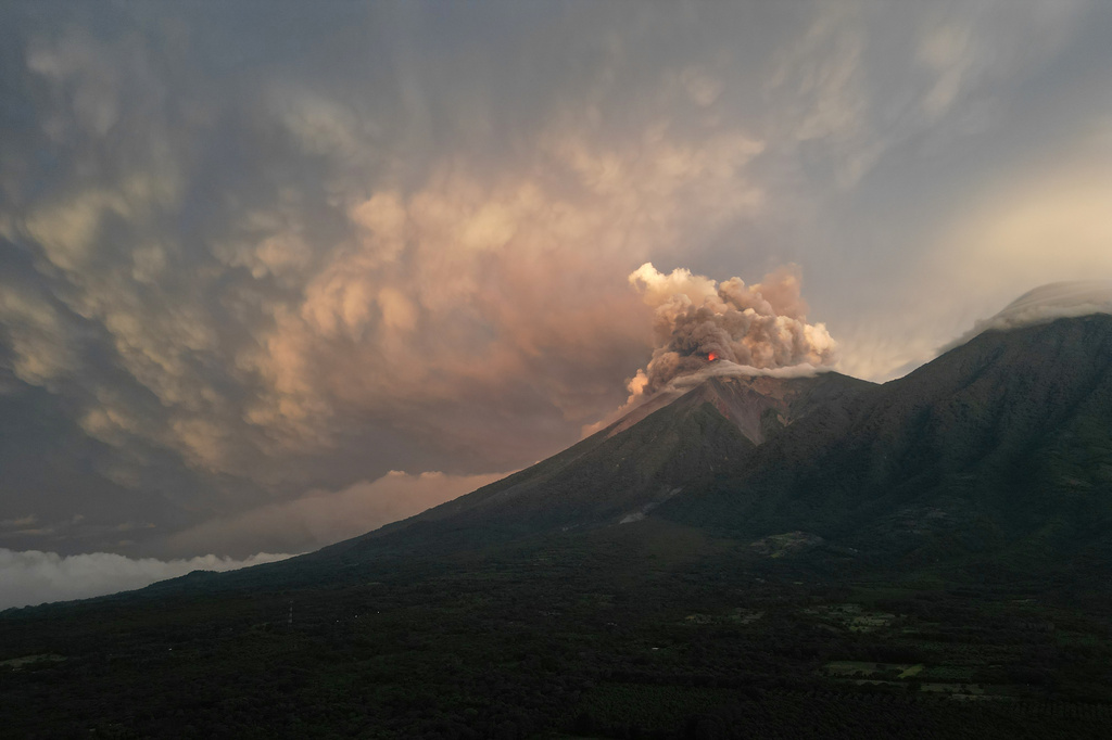 Lava flows and clouds of ash out of the crater of the Fuego Volcano, as seen from San Juan Alotenango, Guatemala, Tuesday, Aug. 4, 2026. (AP Photo/Moises Castillo)
