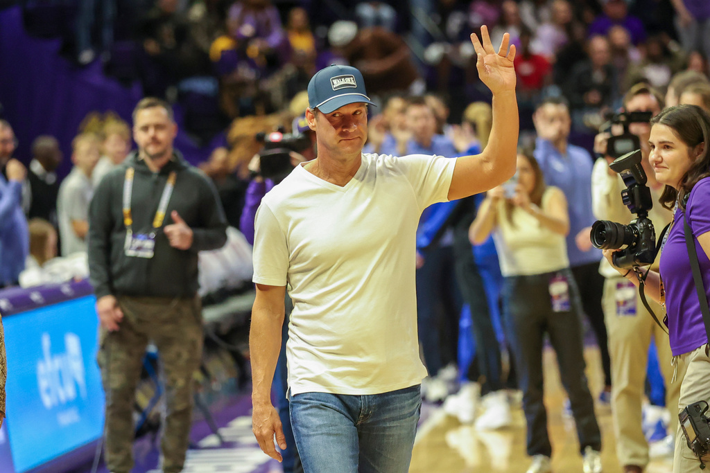 LSU head football coach Lane Kiffin waves to the crowd in the first half of an NCAA college basketball game against Kentucky in Baton Rouge, La., Thursday, Jan. 1, 2026. (AP Photo/Peter Forest)