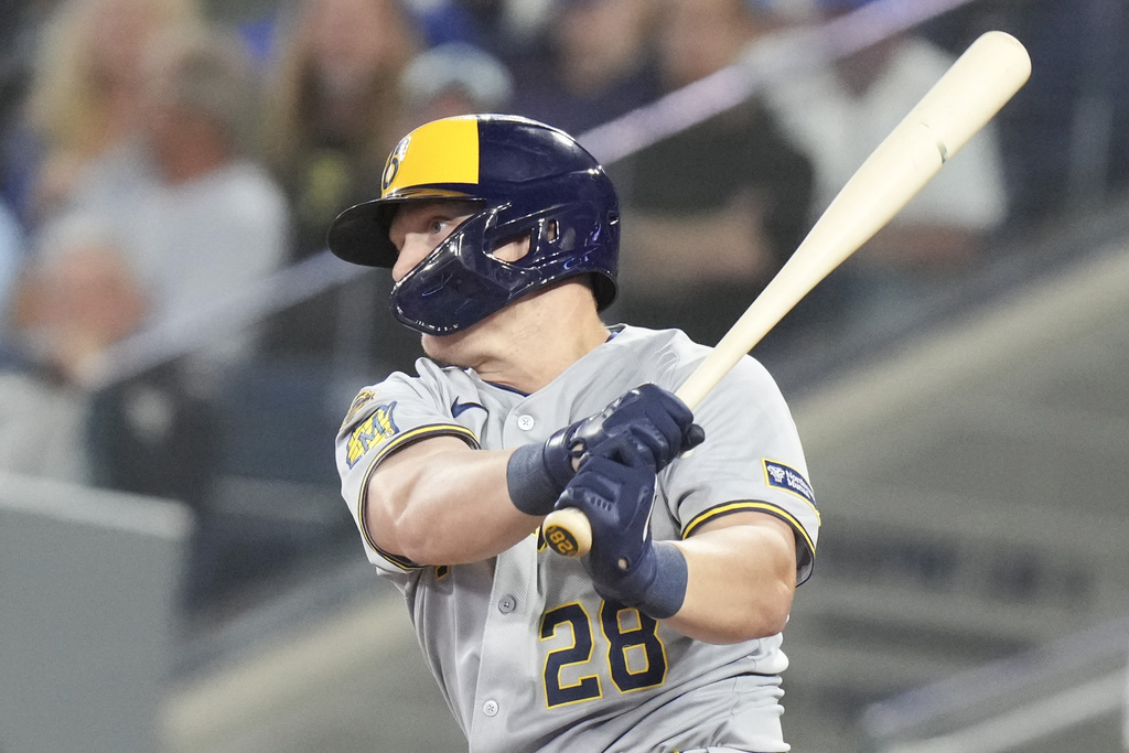 Milwaukee Brewers' Andrew Vaughn (28) hits an RBI single against the Toronto Blue Jays during the sixth inning of a baseball game in Toronto on Friday, August 29, 2025. (Chris Young/The Canadian Press via AP)