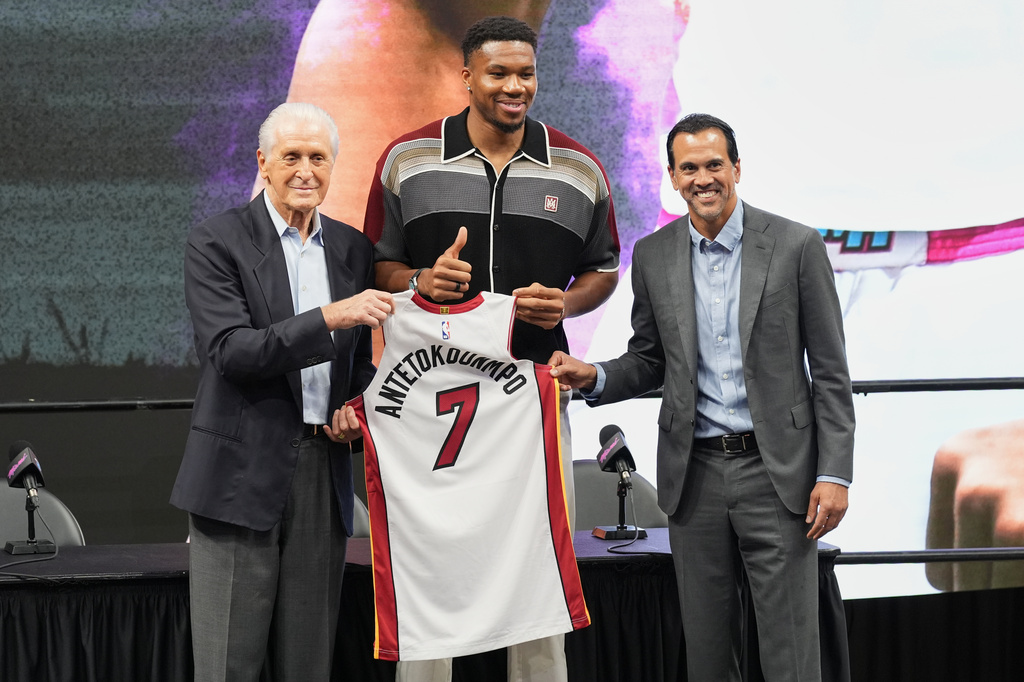 Miami Heat President Pat Riley, left, head coach Erik Spoelstra, right, stand with Giannis Antetokounmpo as he is introduced to the team Thursday, July 16, 2026, in Miami. (AP Photo/Marta Lavandier)