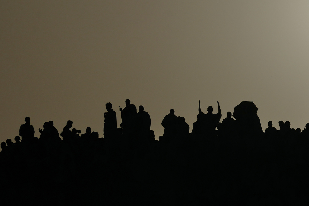 Muslim pilgrims are silhouetted as they pray at top of the rocky hill known as the Mountain of Mercy, on the Plain of Arafat, during the annual Hajj pilgrimage near the holy city of Mecca, Saudi Arabia, Tuesday, May 26, 2026. (AP Photo/Altaf Qadri)